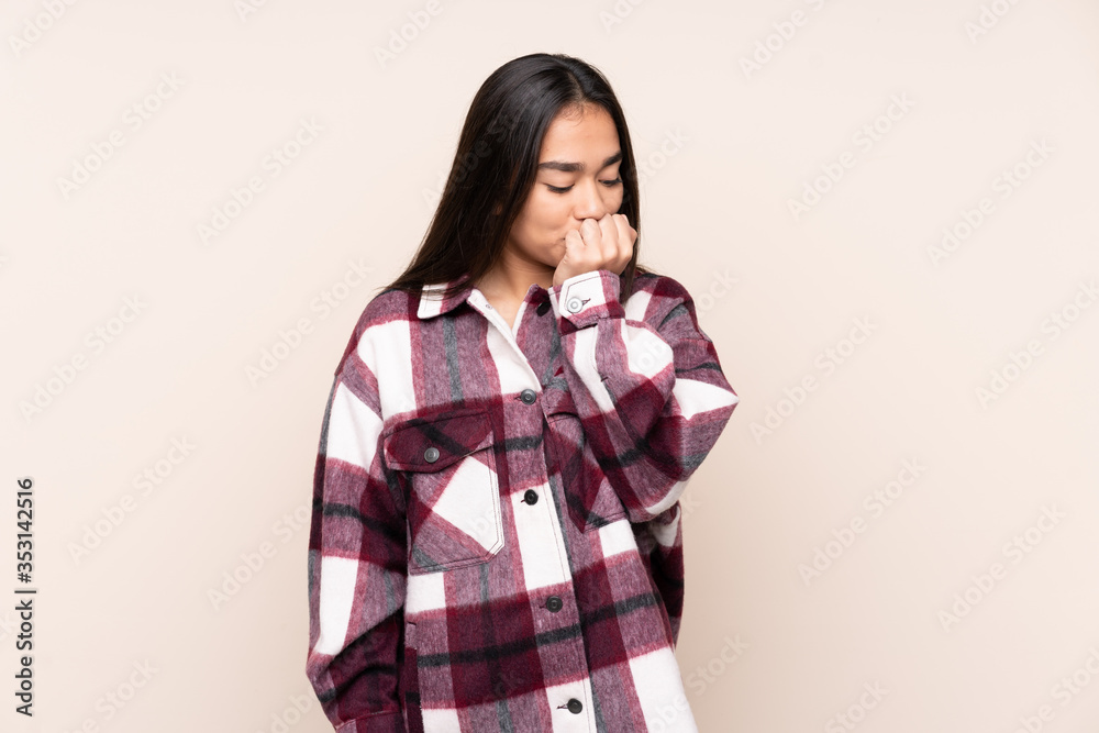 Young Indian woman isolated on beige background having doubts Young Indian woman isolated on beige background having doubts