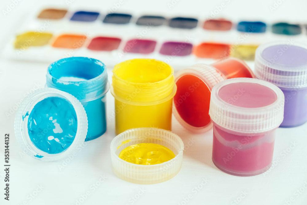Colorful gouache paints on white wooden table. Copy, empty space for text Colorful gouache paints on white wooden table. Copy, empty space for text
