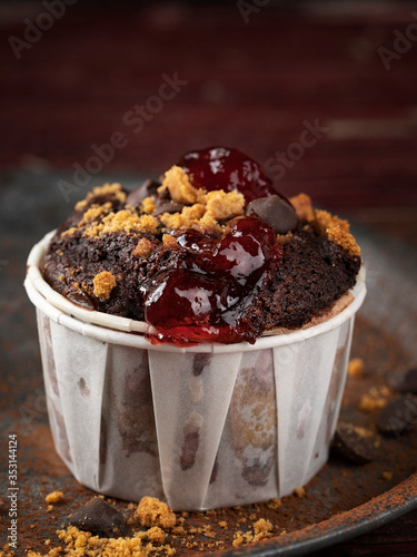 Wallpaper Mural Muffin with chocolate topping, jam and crumbled cookies on wooden dark maroon background, copy space. Homemade bakery concept. Torontodigital.ca