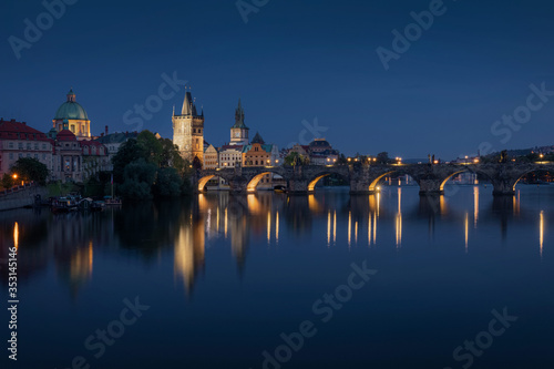 Prague skyline and bridge over river at night. Czech Republic.