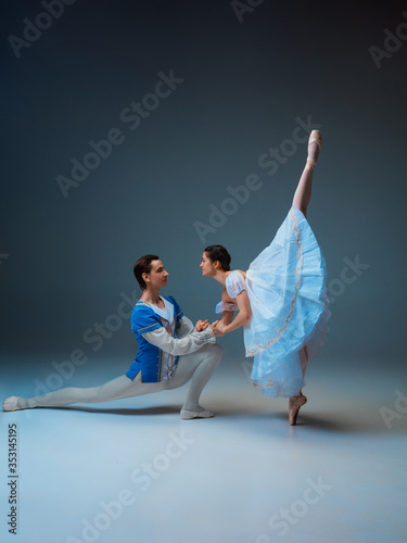 Young and graceful ballet dancers as Cindrella fairytail characters on studio background. Art, motion, action, flexibility, inspiration concept. Flexible caucasian ballet dancers posing, dancing.