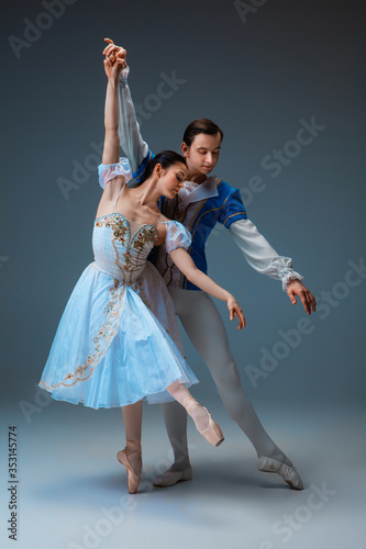 Murais de parede Young and graceful ballet dancers as Cindrella fairytail characters on studio background