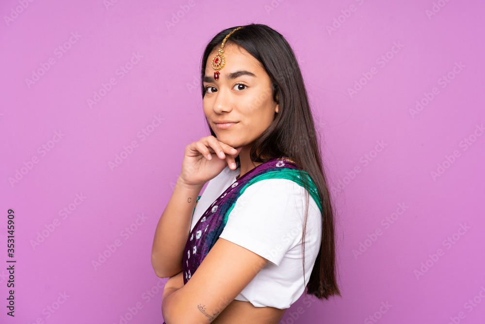 Young Indian woman with sari over isolated background Young Indian woman with sari over isolated background