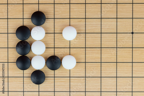 Simple training position of black and white stones on the playing field (gohan) of Chinese game go