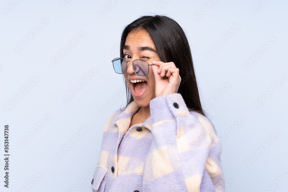 Young Indian woman isolated on blue background Young Indian woman isolated on blue background