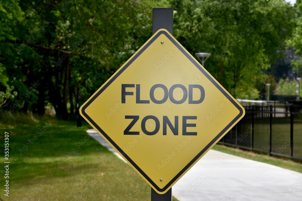 A flood zone warning sign in the park