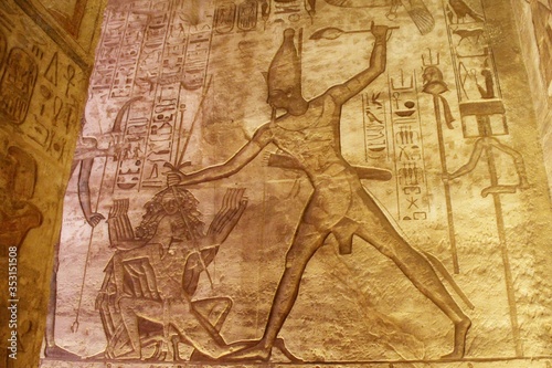 Fotografie, Obraz Wall carving showing the King holding a a war prisoner by the head in Abou simbe