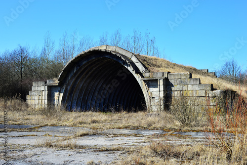 Fotografija An old airfield with abandoned aircraft hangar military landscape