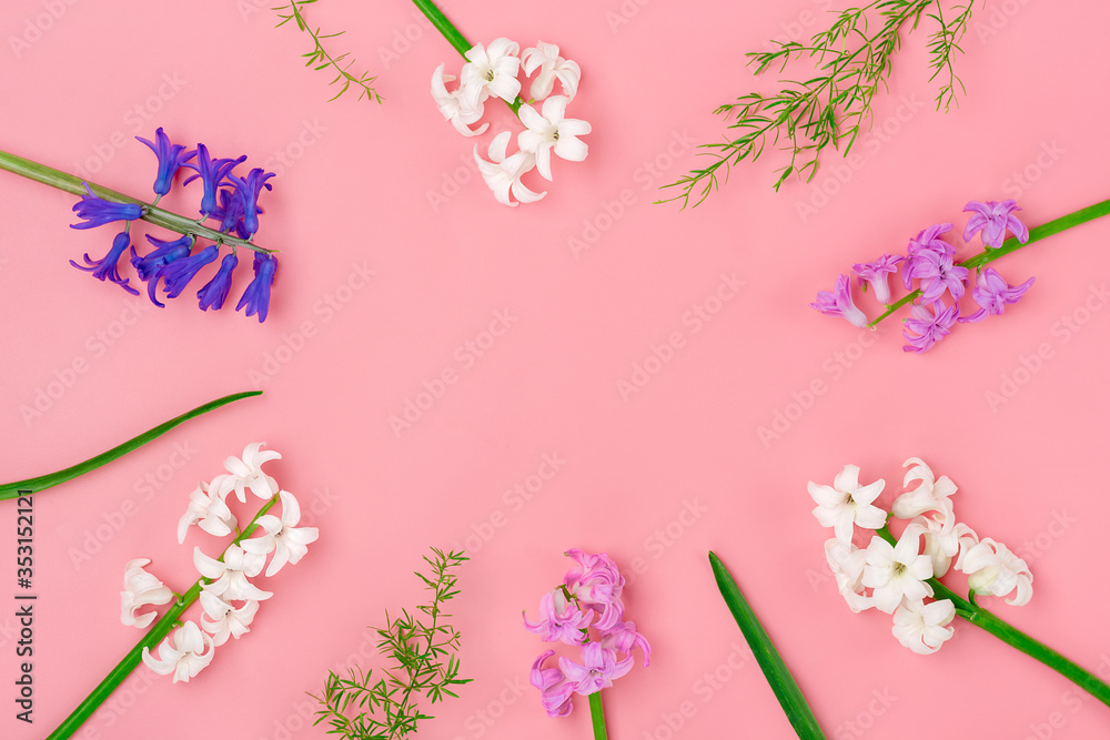 frame from bouquet of spring flowers of white and lilac hyacinths on pink background Top view Flat lay Holiday card Hello spring concept