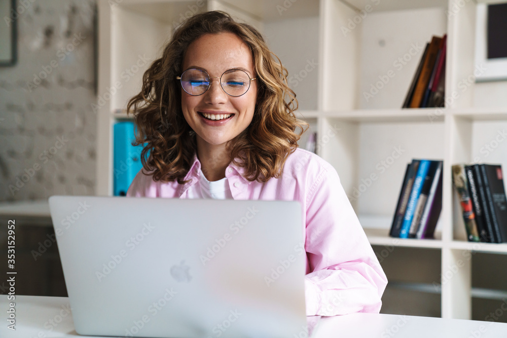 Smiling young girl student studying on laptop computer Smiling young girl student studying on laptop computer
