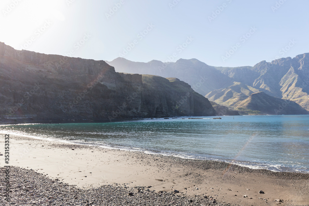 small beach in a Canarian town with large mountains in the background