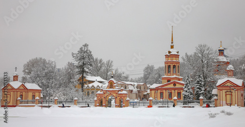 Church in Altufevo in winter, against the background of a snow-covered forest photo