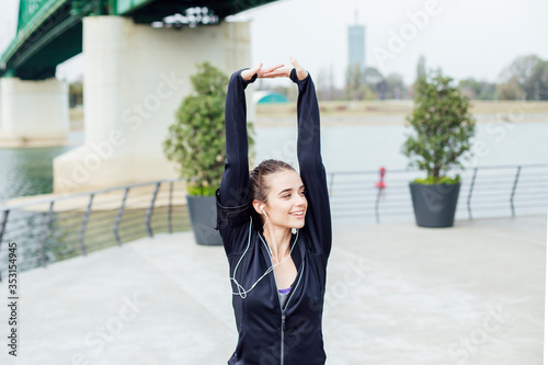 Fit young woman with earpho...