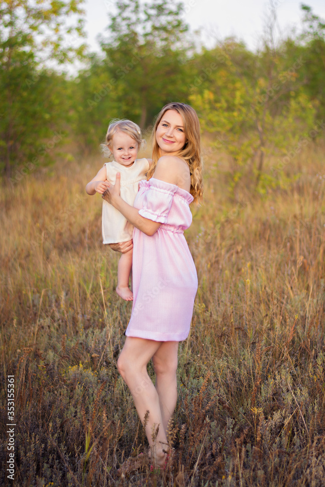 mother and little daughter in autumn park