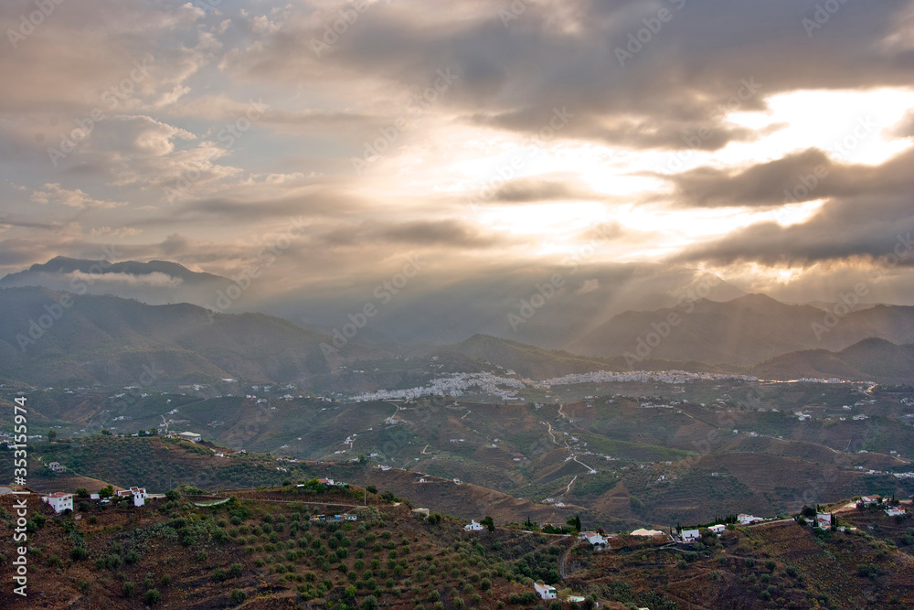 Storm clouds surrounding The Moorish village of Frigiliana nestling in the mountains, Costa del Sol, Andalucia, Spain
