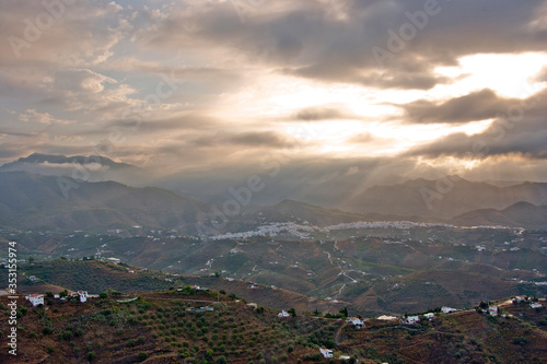 Storm clouds surrounding The Moorish village of Frigiliana nestling in the mountains, Costa del Sol, Andalucia, Spain