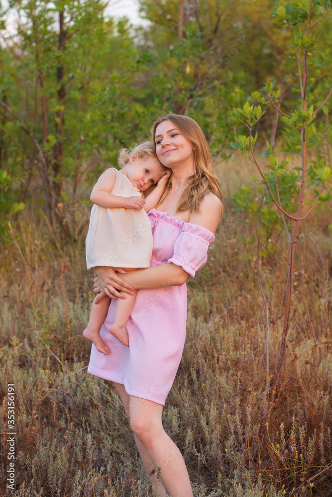 mother and little daughter in autumn park