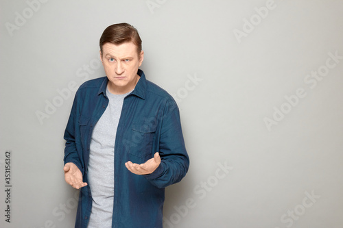 Portrait of angry man raising hand and making demands or rebuking