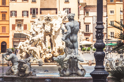 Statues of the fountains of Piazza Navona in the historic center of Rome in Italy. Fontana del Moro in the foreground and Fontana dei Quattro Fiumi in the distance.