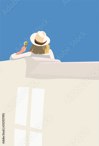 A blonde woman eating ice cream on the beach looking out to sea