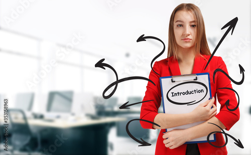 Business, technology, internet and network concept. Young businessman shows a keyword: Introduction