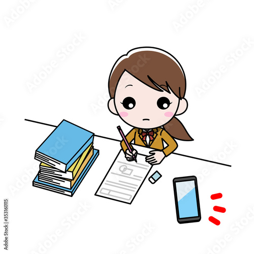 机に向かって勉強している女の子がスマホを気にしている