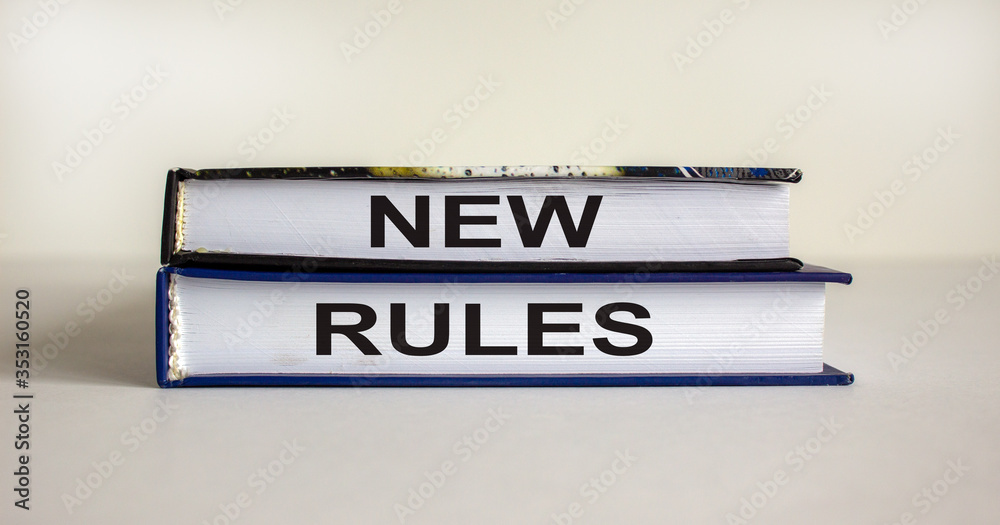 Books with text 'new rules' on beautiful white background. Business concept, copy space.