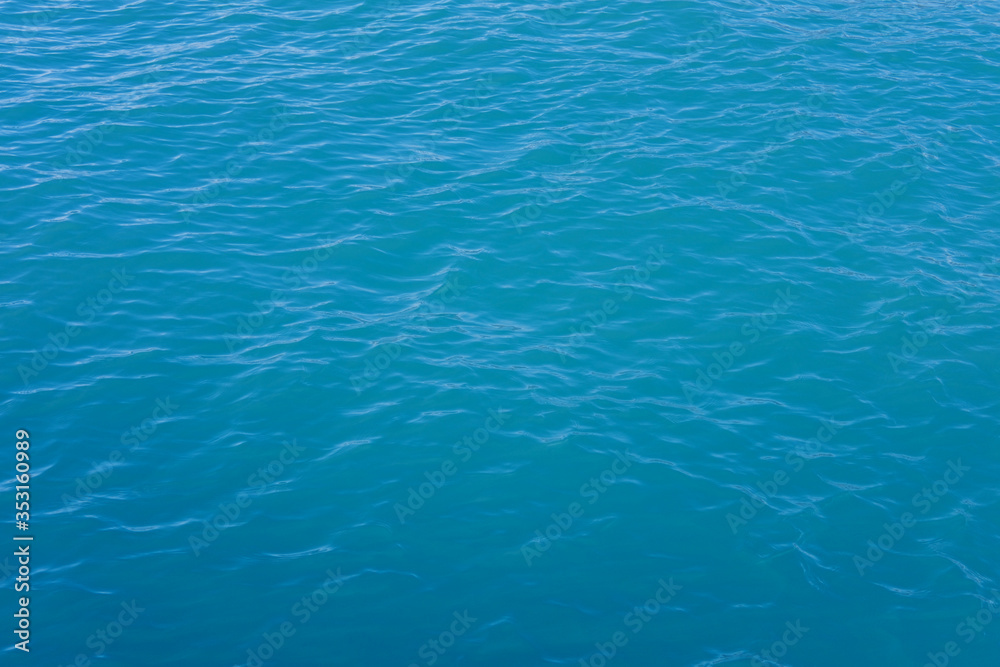 Fototapeta premium Texture of the sea or ocean with white lamb waves rolling to the shore.