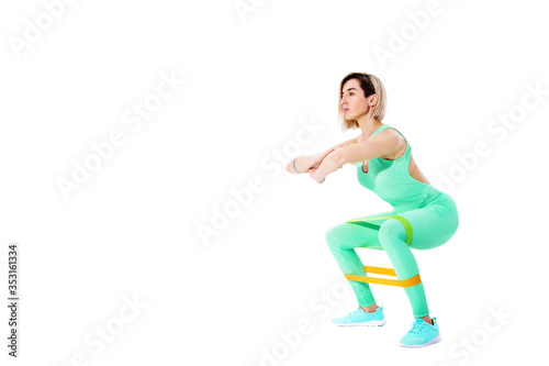 Woman exercising fitness resistance bands in studio silhouette isolated on white background.