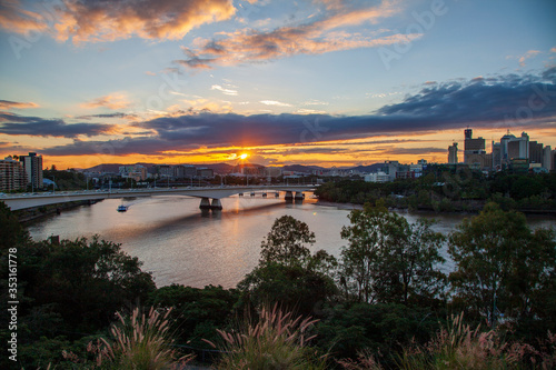 A beautiful sunset paints the sky over the Victoria Bridge crossing the Brisbane River in Brisbane, Australia.