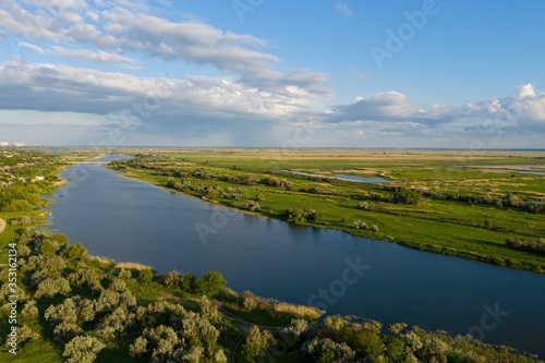 Aerial view of green meadow and beautiful river. Rural landscape. 
