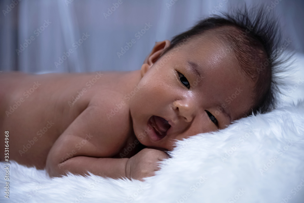 Face of  newborn baby crying.on background
