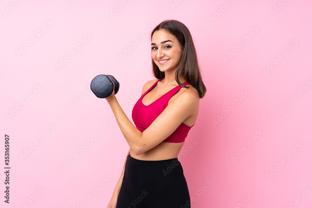 Young sport girl over isolated pink background making weightlifting Young sport girl over isolated pink background making weightlifting