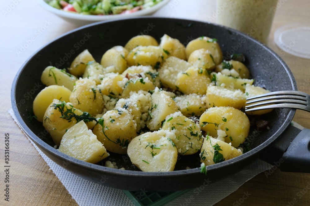 Potatoes with melted cheese and cheese in a pan Potatoes with melted cheese and cheese in a pan