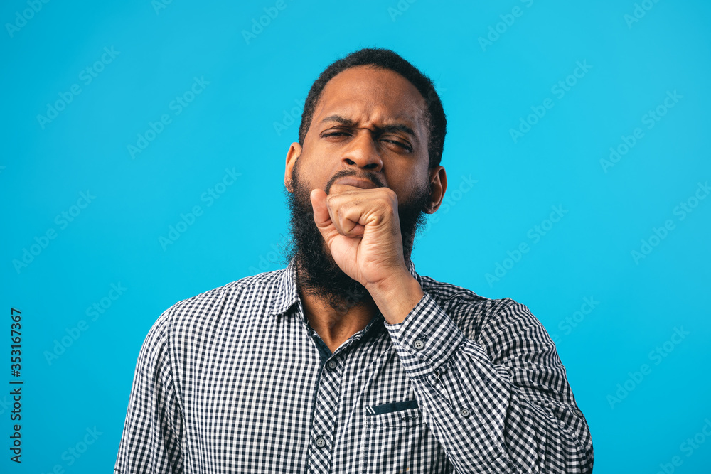 Tired black man yawning covering open mouth with hand Tired black man yawning covering open mouth with hand
