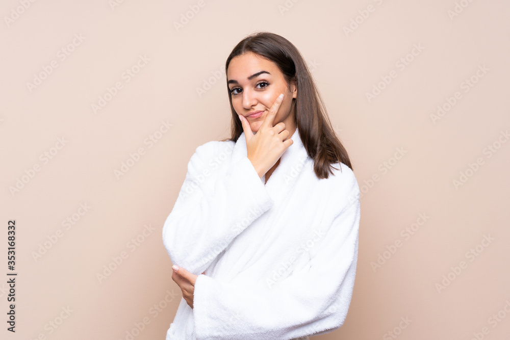 Young girl in a bathrobe over isolated background thinking an idea Young girl in a bathrobe over isolated background thinking an idea