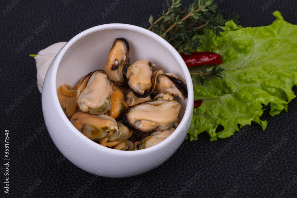 Pickled mussels in the bowl served pepper, garlic and salad Pickled mussels in the bowl served pepper, garlic and salad