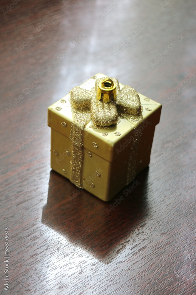 Christmas toy golden box on the table Christmas toy golden box on the table