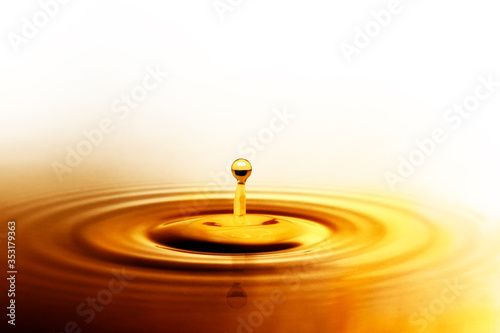 Liquid gold or olive oil drop and ripple wave,abstract background