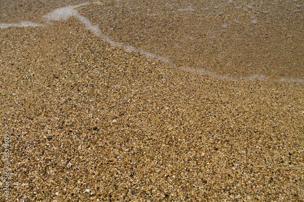 Grained sand on sea beach texture