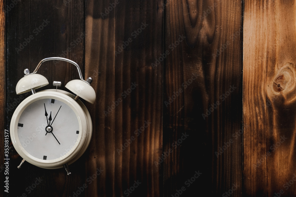 Alarm clock showing almost 12 o clock, on old wooden floor background - Time concept. Alarm clock showing almost 12 o clock, on old wooden floor background - Time concept.