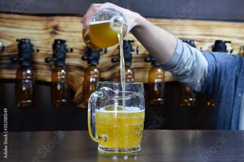 Bartender pours beer intj a glass photo