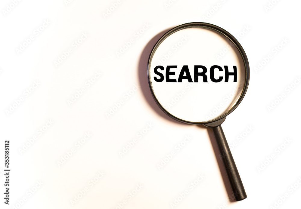 Search concept. Magnifying glass on a gray background with the words search. Search concept. Magnifying glass on a gray background with the words search.
