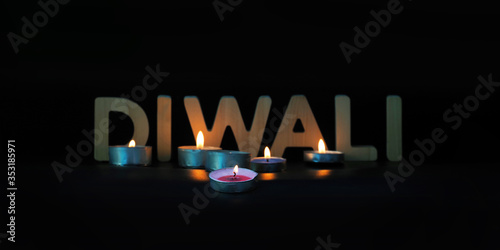 Diwali greeting card, illuminated candles, Diwali text, panoramic view