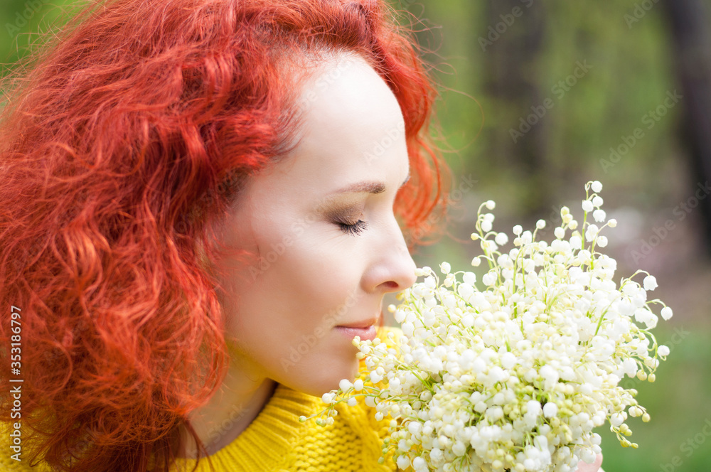 close up red haired pretty girl sniffs bouquet of white flowers close up red haired pretty girl sniffs bouquet of white flowers