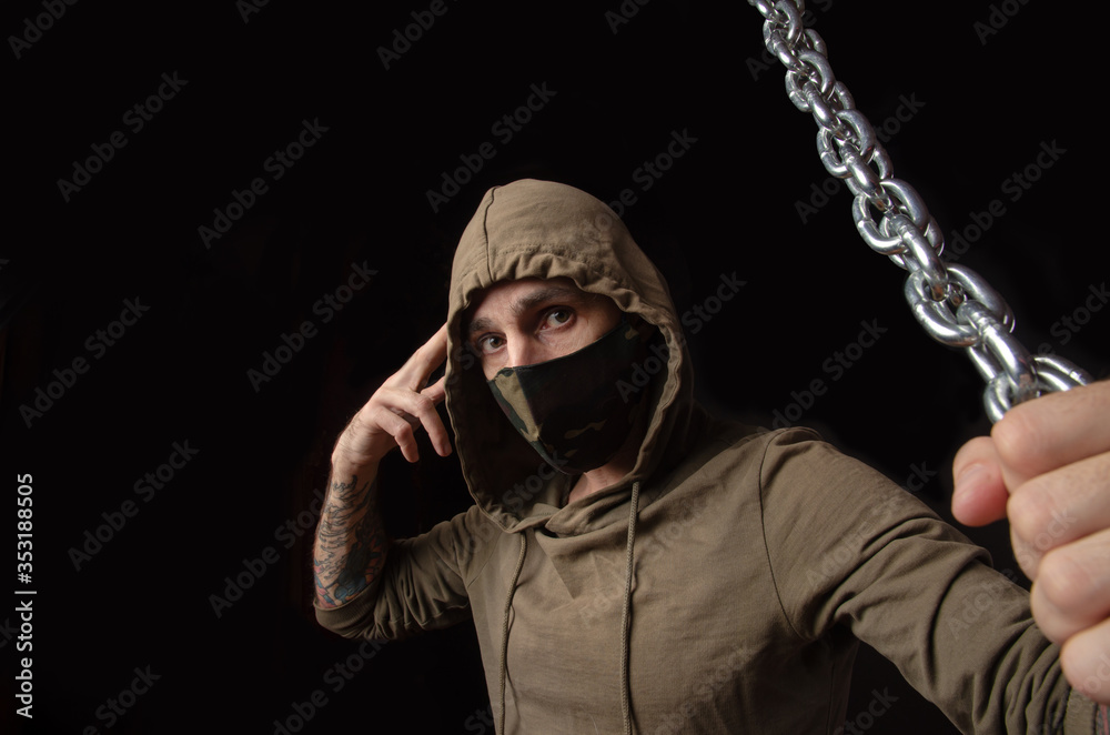 guy in a mask and hood with chains guy in a mask and hood with chains