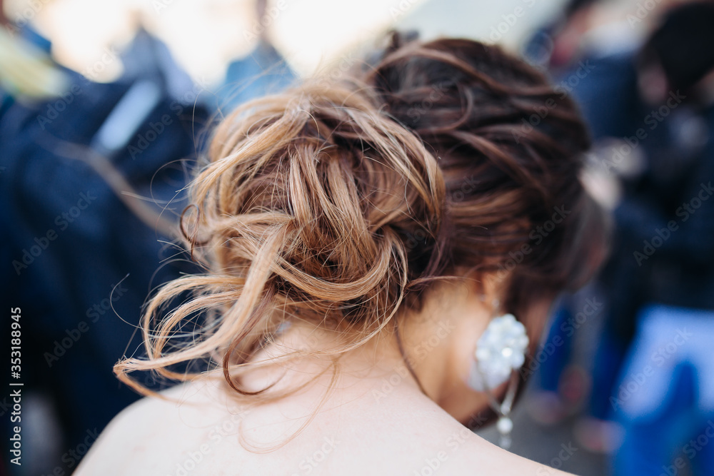Fototapeta premium The beauty of a wedding hairstyle. Bride. A brunette brown-haired with curly hair.Hair decoration