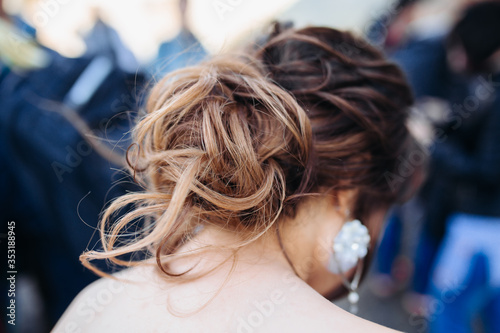 The beauty of a wedding hairstyle. Bride. A brunette brown-haired with curly hair.Hair decoration