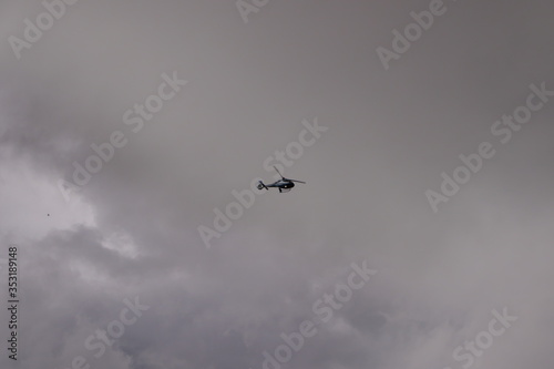 helicopter flying in the cloudy sky © conpuli