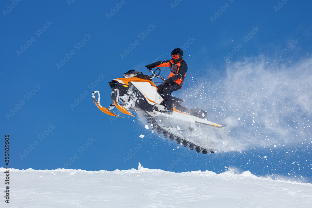 snowmobile rider jumping through snow. RIDER MAN WITH HELMET JUMPING WITH SNOWMOBILE BETWEEN SKY ON WINTER. a bright suit and a snow motorcycle. Extreme winter sport. high resolution and photo quality snowmobile rider jumping through snow. RIDER MAN WITH HELMET JUMPING WITH SNOWMOBILE BETWEEN SKY ON WINTER. a bright suit and a snow motorcycle. Extreme winter sport. high resolution and photo quality